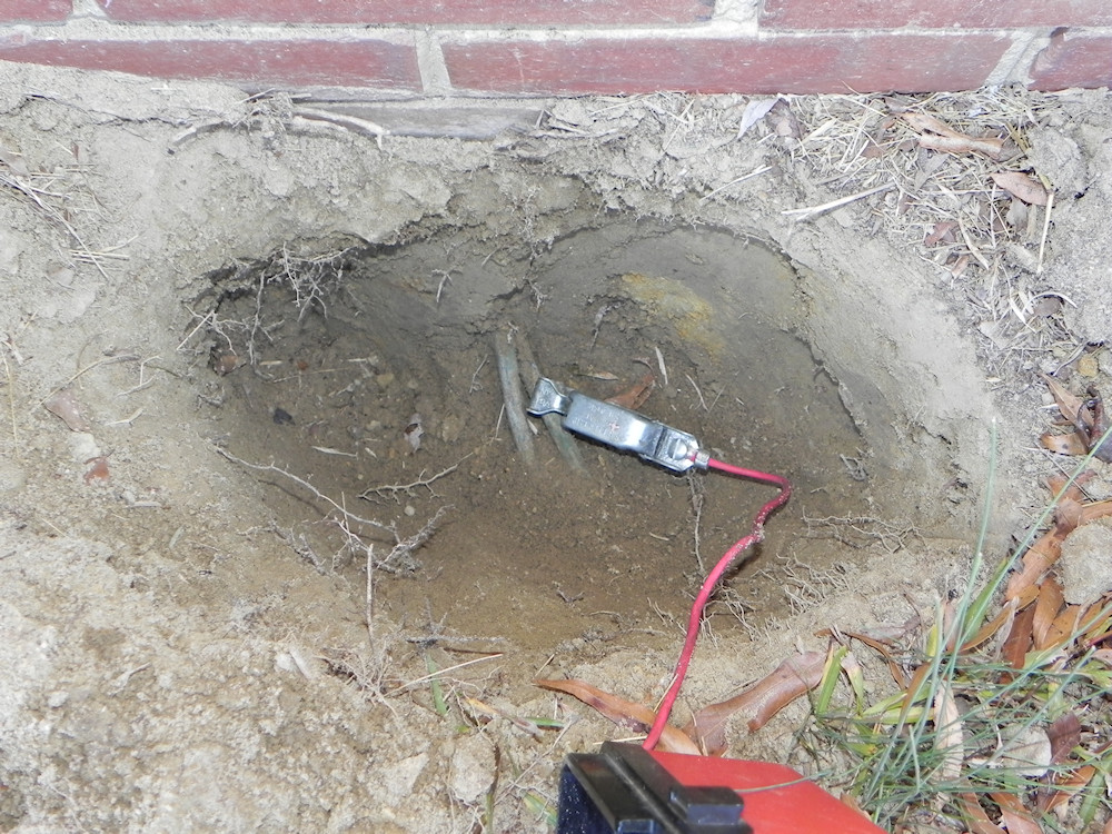 Tracing copper fuel lines from foundation wall to former underground oil tank location.