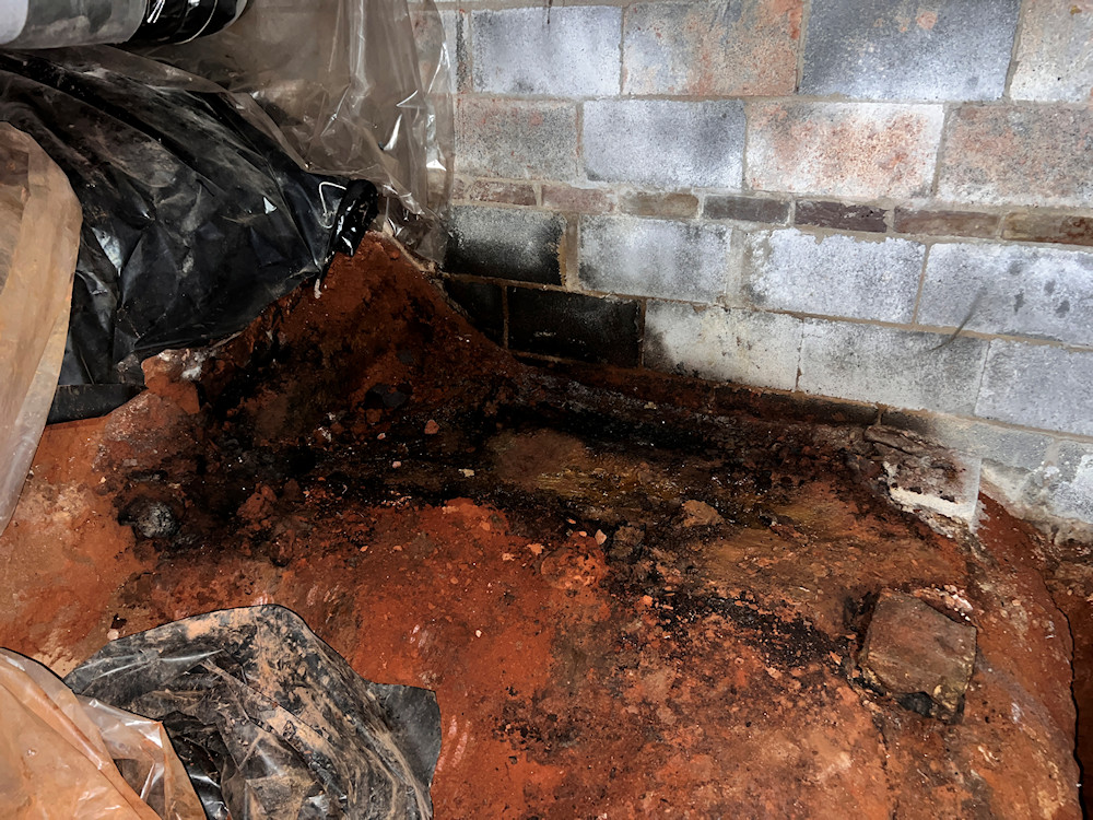View of discolored contaminated soil beneath former location of the aboveground tank View of discolored contaminated soil beneath former location of the aboveground tank